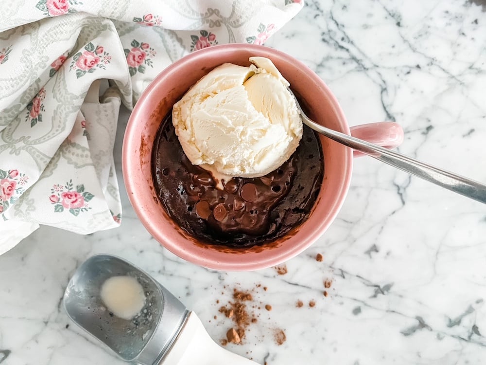 Chocolate Mug Cake from above with a scoop of vanilla ice cream and a spoon
