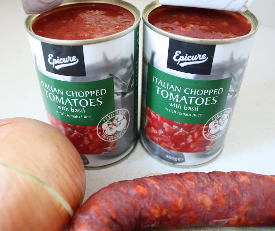 Two tins of chopped tomatoes with basil