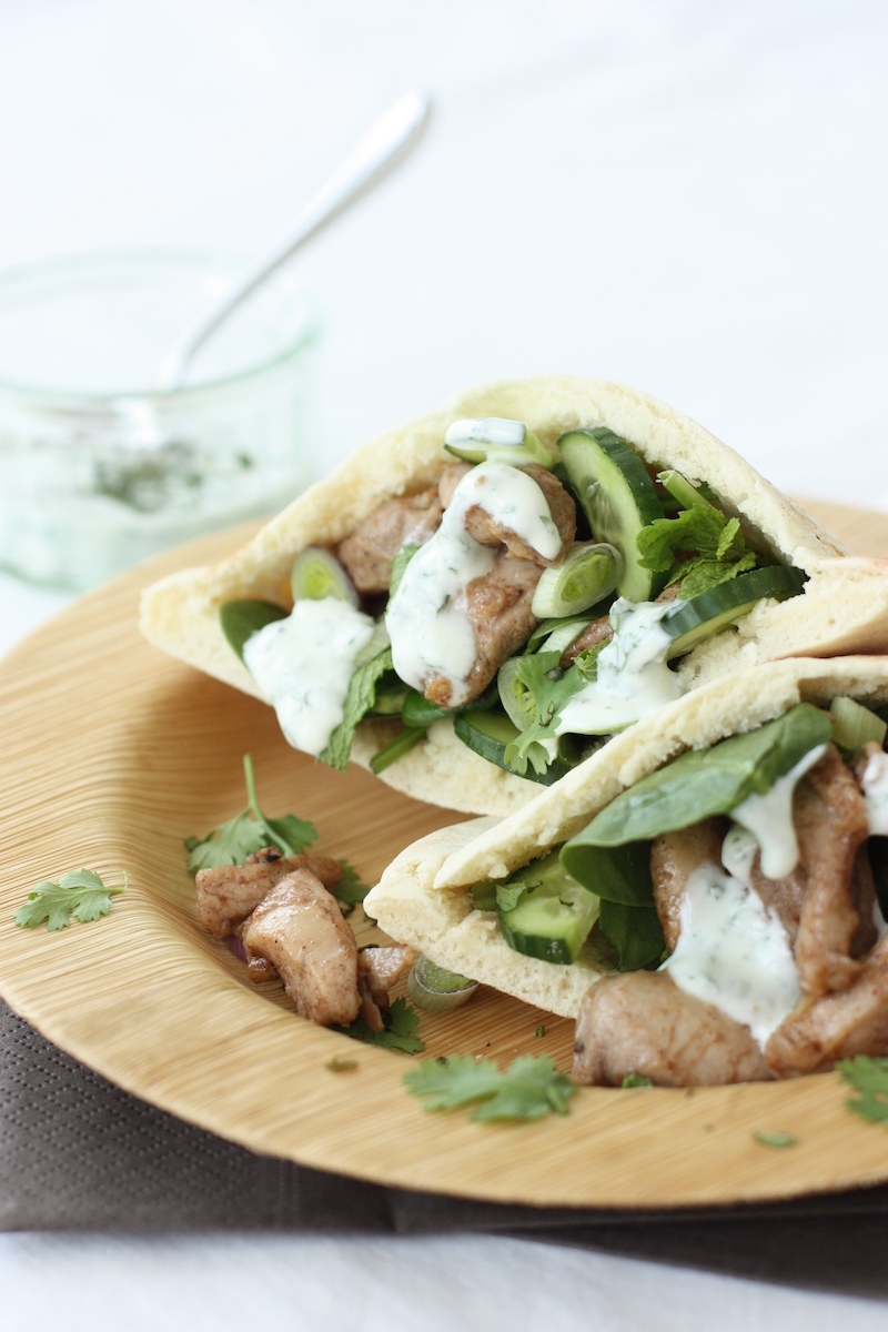 Baharat Chicken Flatbreads on a bamboo plate with a yoghurt dressing on the side