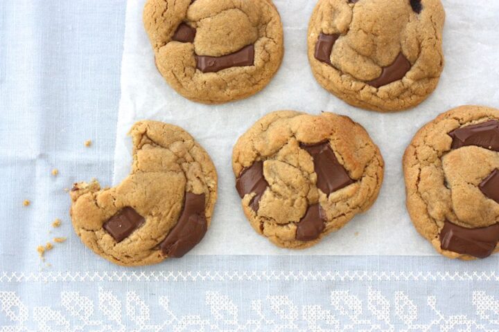 Five Dark Chocolate and Ginger Ben's Cookies taken from above, one with a bite taken out