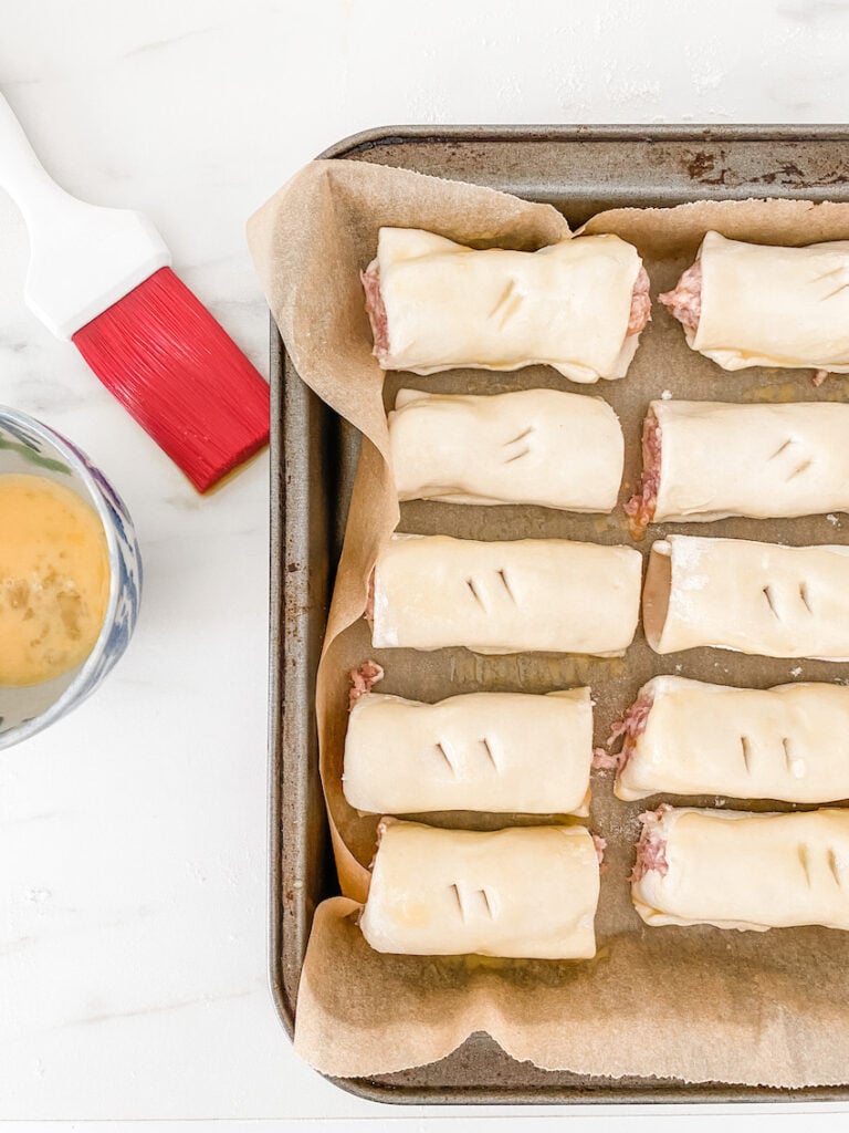 Easy Homemade sausage rolls, uncooked and glazed and ready to go in the freezer
