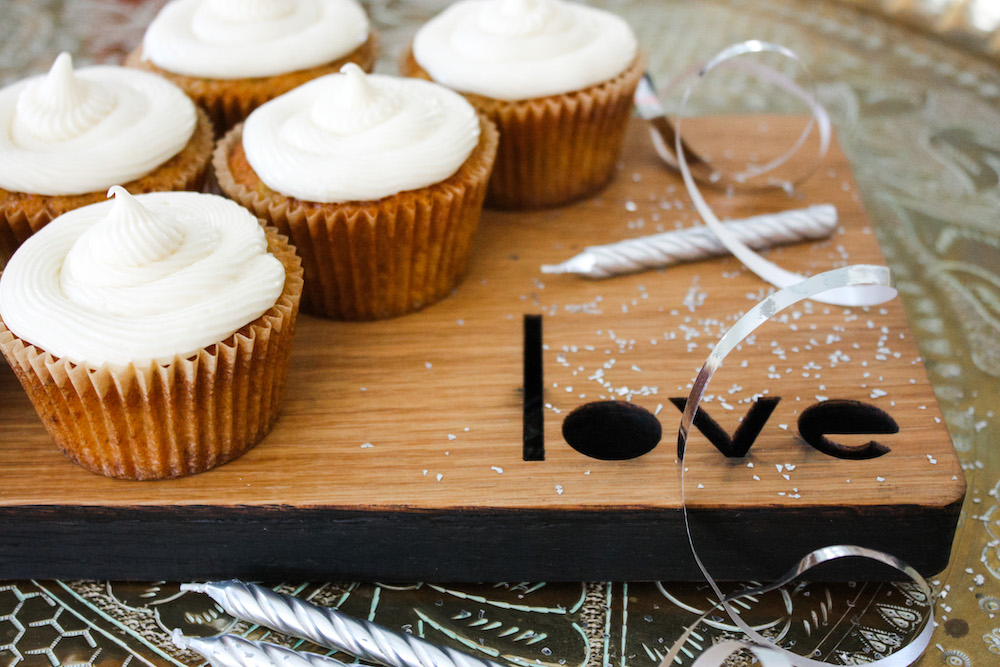 Carrot Cakes on a wooden board with candles and ribbon