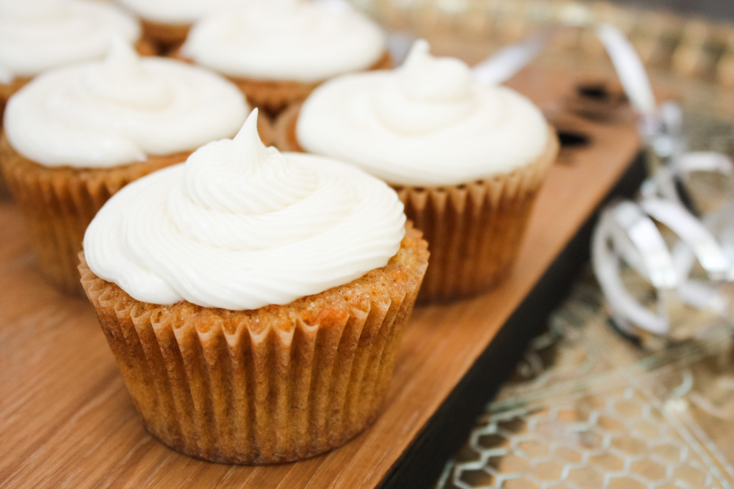 Carrot Cakes frosted and on a wooden board