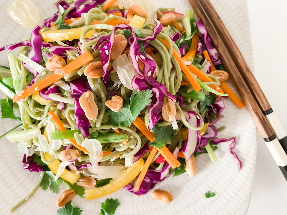 Thai Style Rainbow Noodle Salad on a white plate with chopsticks