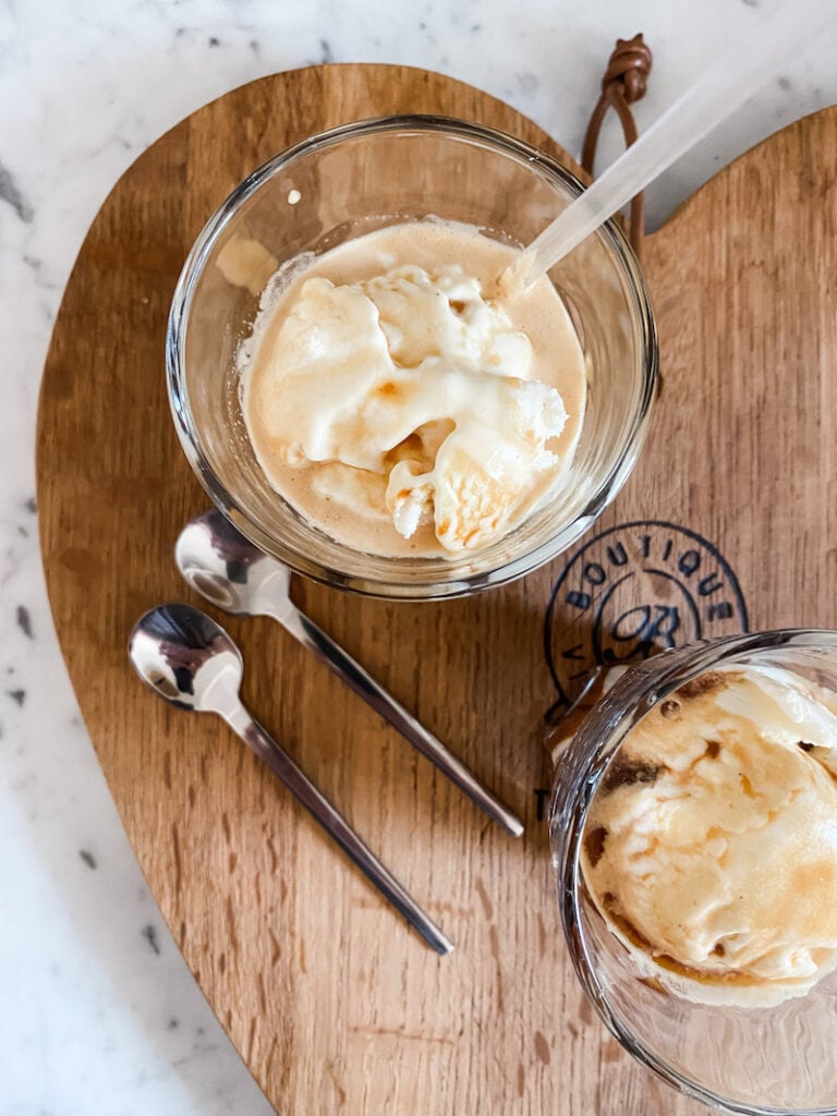Affogato in a glass on a heart shaped wooden board