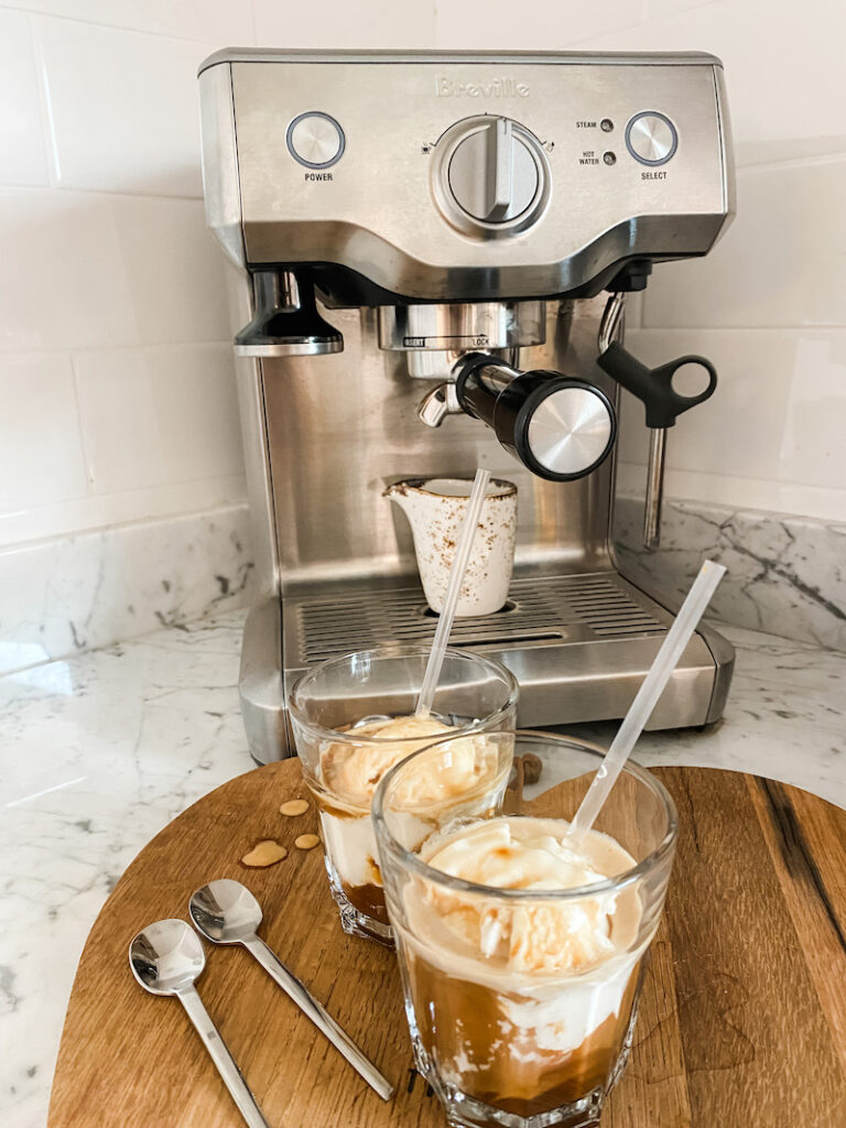 Affogato in front of a coffee machine, on a heart shaped wooden board