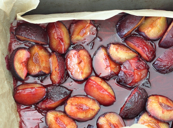 Roasted plums with vanilla sugar in a baking tray