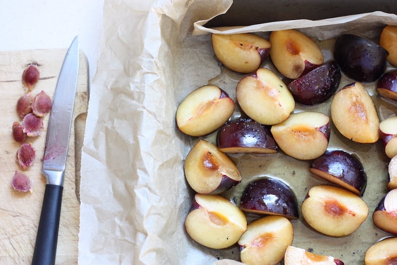 Roasted Plums with Vanilla sugar raw plums on a baking tray
