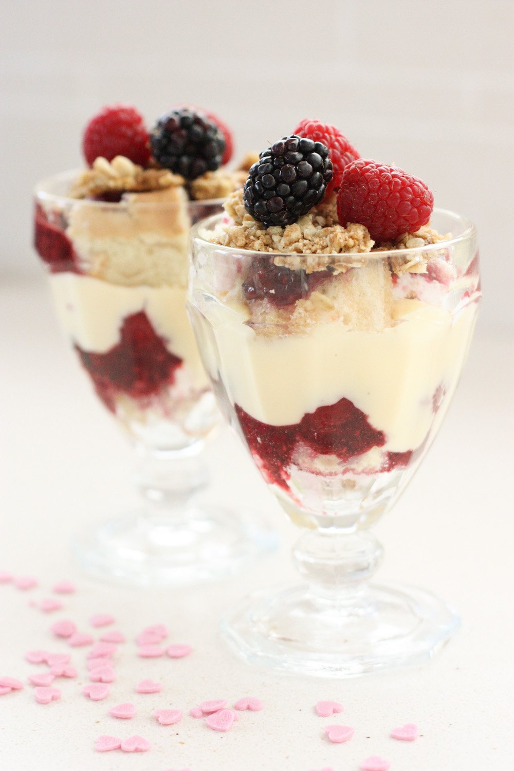 Individual Boozy Trifles in glass dishes with pink confetti in the foreground