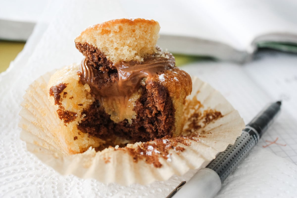 Chocolate and Caramel Cupcakes half eaten on a piece of kitchen roll