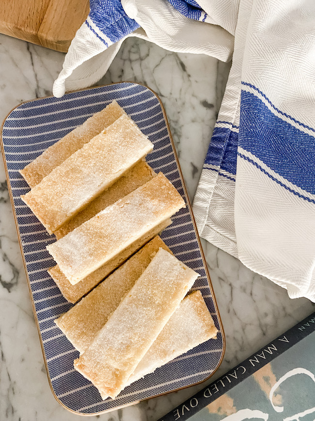 Traditional Buttery Shortbread on a blue tray with a white tea towel