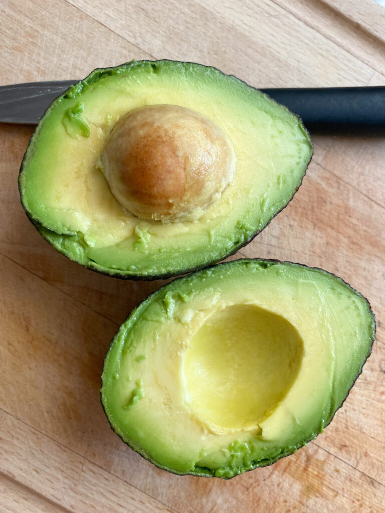 An avocado cut in two pieces