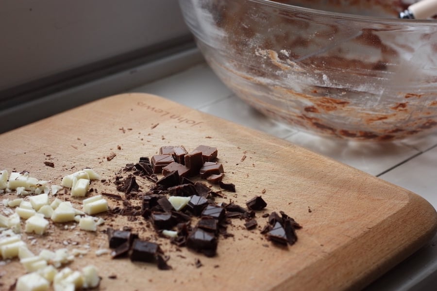 Chopped chocolate and an empty bowl for Chocolate Fudge Cookies