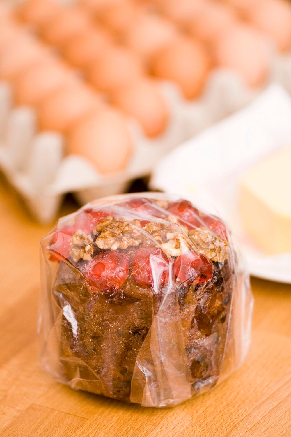 A small Christmas cake wrapped in cellophane