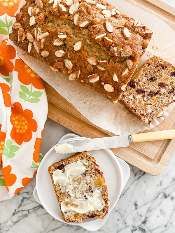 Apricot, Dried Cherry and Almond Loaf sliced on a wooden board