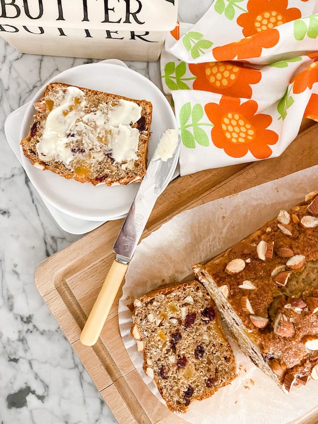 Apricot, Dried Cherry and Almond Loaf sliced on a wooden board