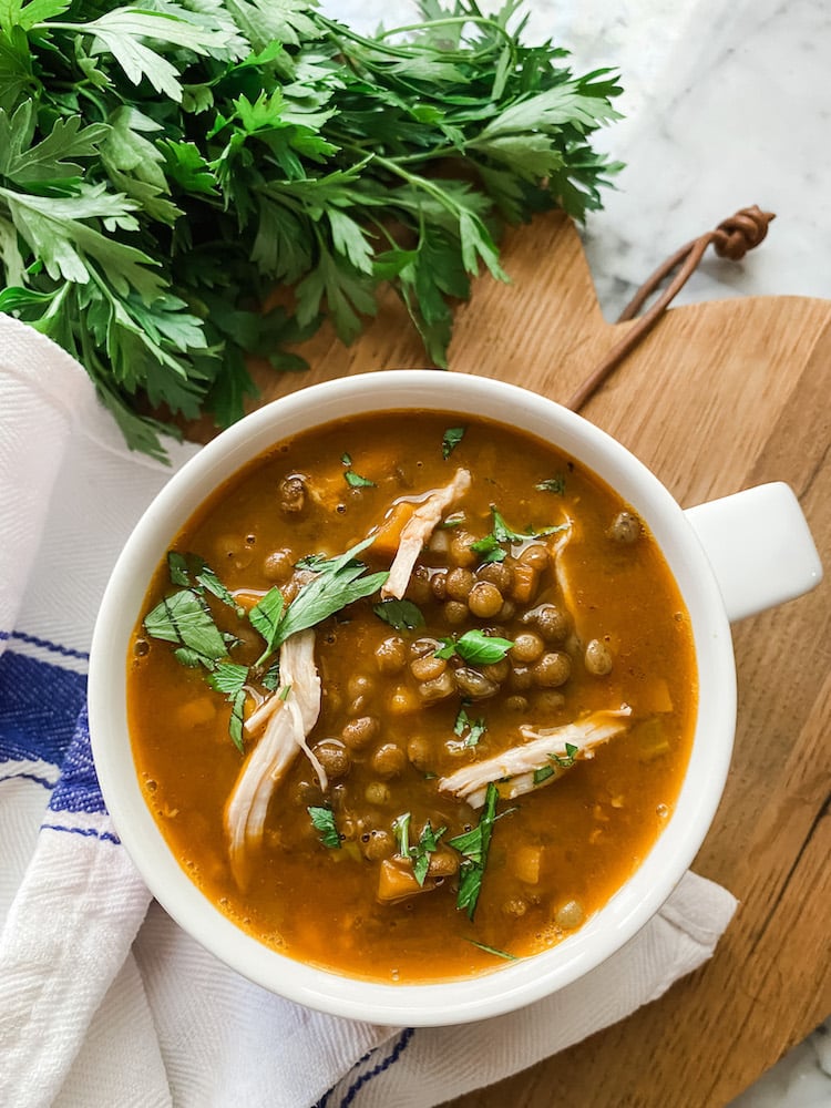 Cosy Chicken and Puy Lentil Soup on wooden board