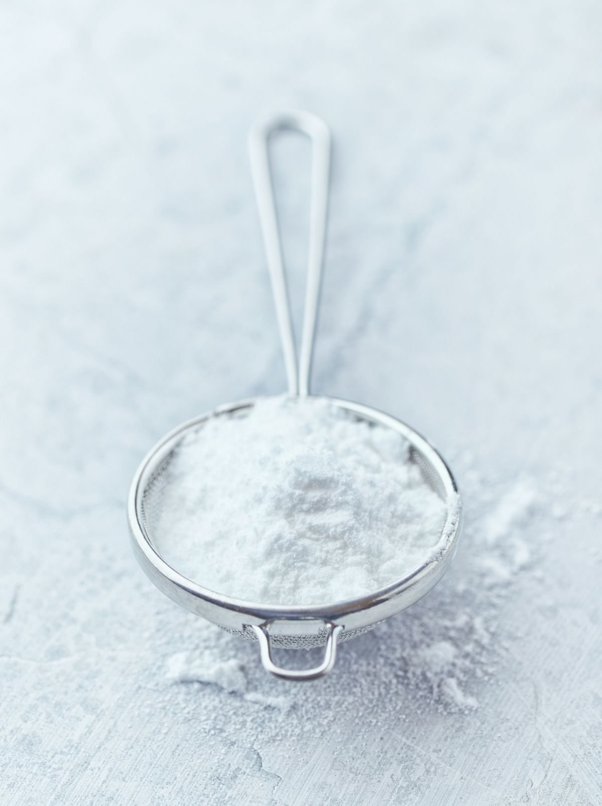 Icing sugar in a small sieve