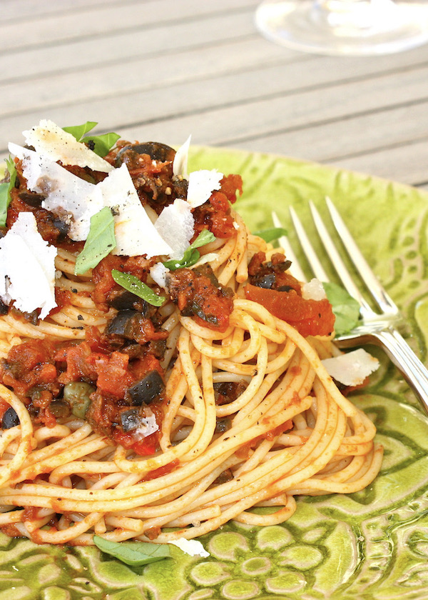 Puttanesca Pasta on green plate